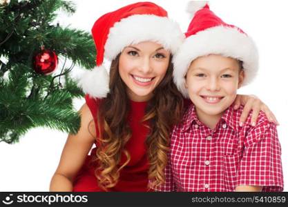 holidays, presents, christmas, x-mas concept - happy mother and child boy in santa helper hats