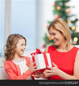 holidays, presents, christmas, x-mas concept - happy mother and child girl with gift box