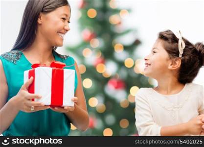 holidays, presents, christmas, x-mas concept - happy mother and child girl with gift box
