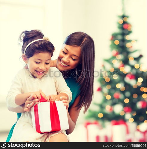 holidays, presents, christmas, x-mas concept - happy mother and child girl with gift box