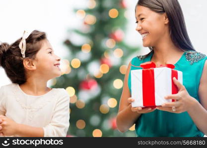 holidays, presents, christmas, x-mas concept - happy mother and child girl with gift box