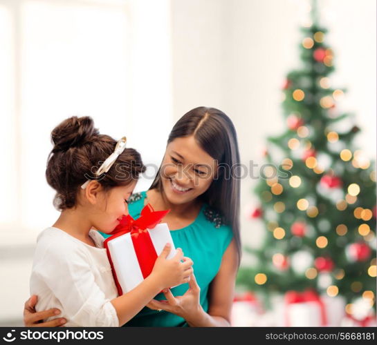 holidays, presents, christmas, x-mas concept - happy mother and child girl with gift box