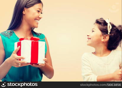 holidays, presents, family, christmas and x-mas concept - happy mother and child girl with gift box