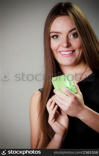 Holidays, presents, love and happiness concept. Beautiful young woman holding an open jewelery green gift for anniversary