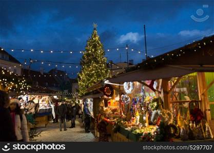 holidays, sale and retail concept - christmas market at old town hall square in tallinn. christmas market at tallinn old town hall square