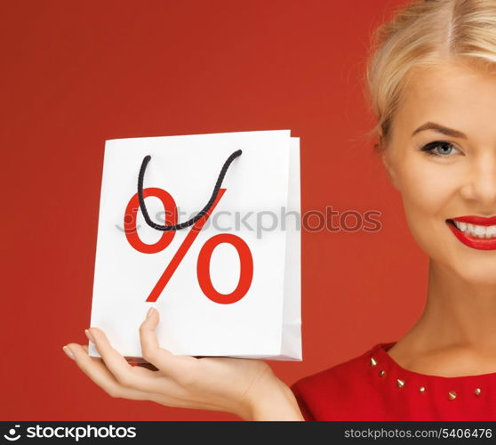 holidays, sale, christmas and shopping concept - woman holding bag with percent sign