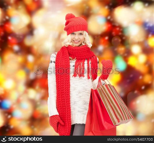 holidays, sale, christmas concept - beautiful teenage girl in winter clothes with shopping bags