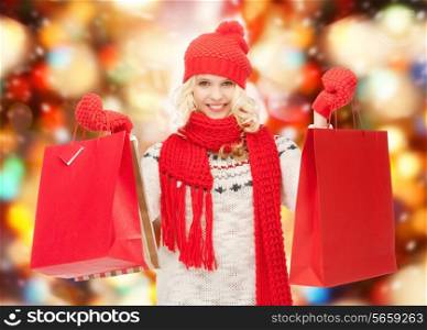 holidays, sale, christmas concept - beautiful teenage girl in winter clothes with shopping bags