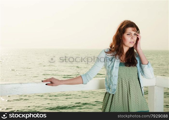 Holidays summer relaxation concept. Young woman relaxing on pier outdoor