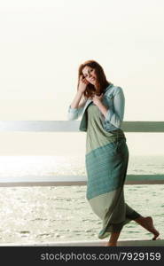 Holidays summer relaxation concept. Young woman relaxing on pier outdoor