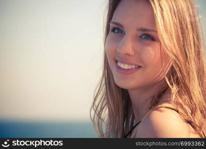 Holidays, summertime and freedom concept. Lovely blonde girl relaxing outdoor by seaside. Lovely blonde girl relaxing outdoor by seaside