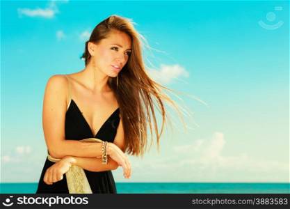 Holidays, summertime travel and freedom concept. Portrait of lovely girl beauty long hair outdoor. Young pretty tanned woman in summer clothing on sky background