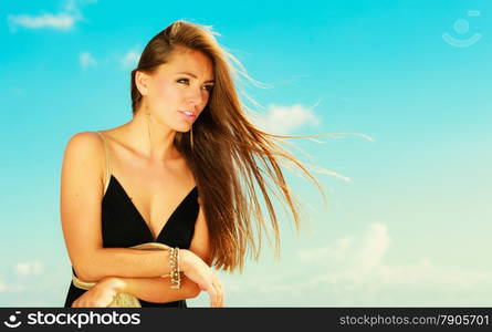 Holidays, summertime travel and freedom concept. Portrait of lovely girl beauty long hair outdoor. Young pretty tanned woman in summer clothing on sky background