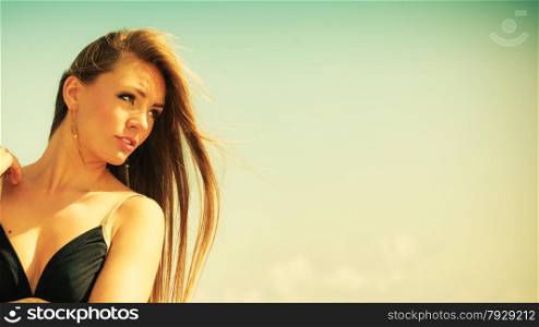 Holidays, summertime travel and freedom concept. Portrait of lovely girl beauty long hair outdoor. Young pretty tanned woman in summer clothing on sky background