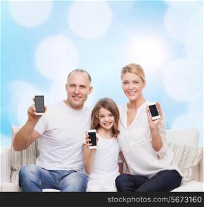 holidays, technology, advertisement and people concept - smiling family with smartphones over blue lights background