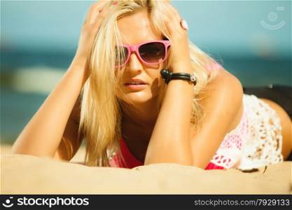 Holidays, vacation and summer fashion concept. closeup attractive blonde girl in pink sunglasses on beach outdoor
