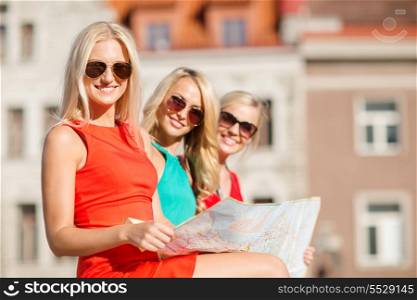 holidays, vacation and tourism concept - three beautiful blonde women with tourist map in the city