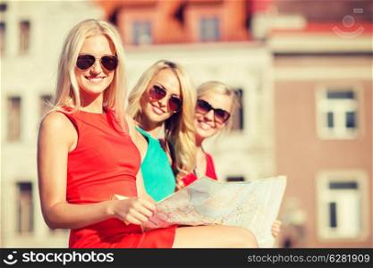 holidays, vacation and tourism concept - three beautiful blonde women with tourist map in the city