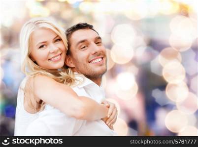 holidays, vacation, dating, love and people concept - happy couple having fun over lights background