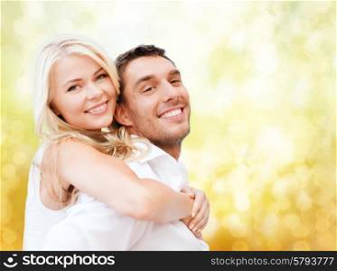 holidays, vacation, dating, love and people concept - happy couple having fun over yellow lights background