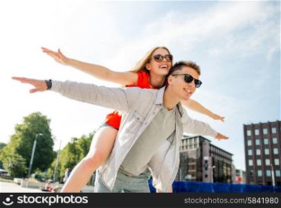 holidays, vacation, love and friendship concept - smiling couple having fun in city