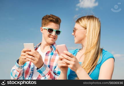 holidays, vacation, love and friendship concept - smiling couple having fun outdoors