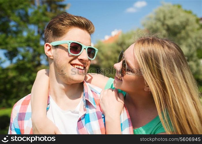 holidays, vacation, love and friendship concept - smiling couple having fun outdoors