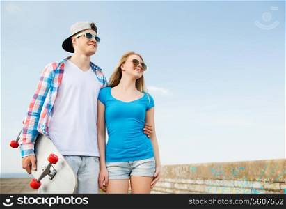 holidays, vacation, love and friendship concept - smiling couple having fun outdoors
