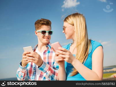 holidays, vacation, love and friendship concept - smiling couple having fun outdoors