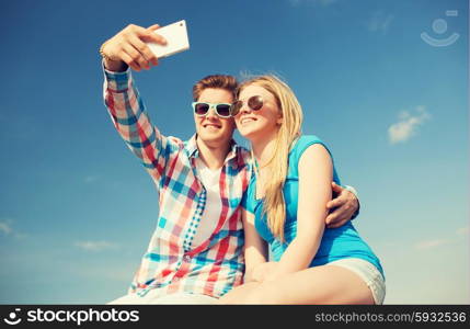 holidays, vacation, love and friendship concept - smiling couple having fun outdoors