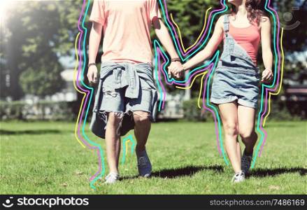 holidays, vacation, love and people concept - happy teenage couple walking in summer park with glowing lines. happy teenage couple walking at summer park