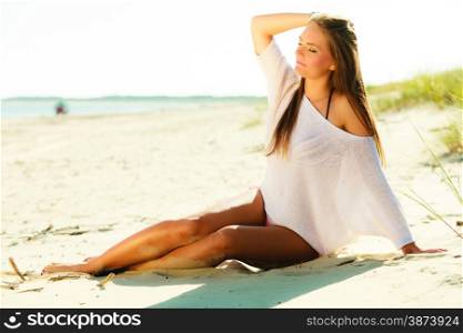 Holidays, vacation tourism and beauty concept. Full length of attractive sexy girl long hair on beach. Young pretty tanned woman in summer clothing relaxing on the sea shore