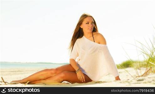 Holidays, vacation tourism and beauty concept. Full length of attractive sexy girl long hair on beach. Young pretty tanned woman in summer clothing relaxing on the sea shore