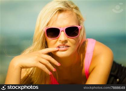 Holidays, vacation travel and freedom concept. Beautiful blonde sexy girl on beach. Young woman relaxing on the sea coast.