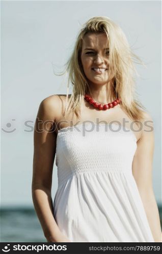 Holidays, vacation travel and freedom concept. Beautiful girl in white dress on beach. Lovely woman portrait outdoor on sky background
