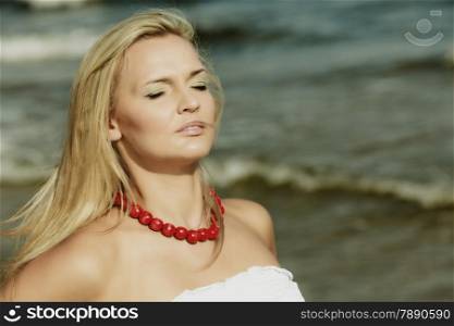 Holidays, vacation travel and freedom concept. Beautiful girl in white dress on beach. Lovely woman portrait outdoor on sea background