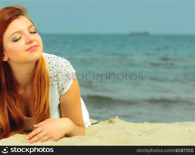 Holidays, vacation travel and freedom concept. Beautiful redhaired happy girl on beach, portrait