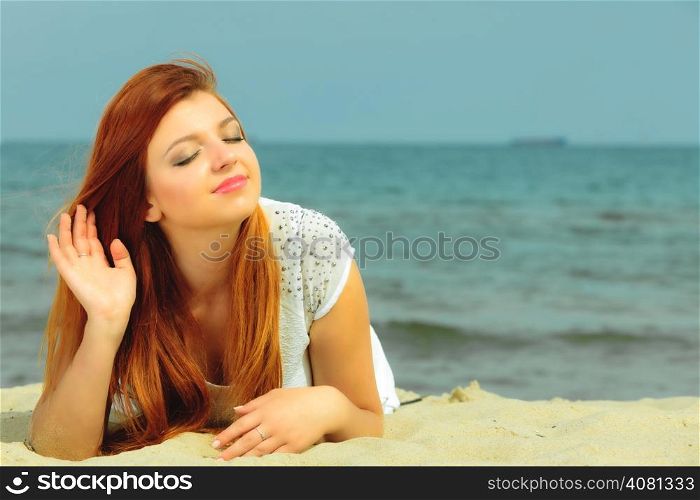Holidays, vacation travel and freedom concept. Beautiful redhaired happy girl on beach, portrait