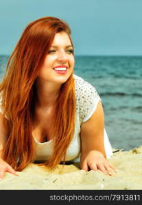 Holidays, vacation travel and freedom concept. Beautiful redhaired happy girl on beach, portrait