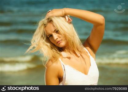 Holidays, vacation travel and freedom concept. closeup portrait of beauty romantic blonde girl outdoor on seashore. Her long hair blowing
