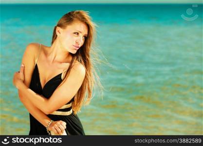 Holidays, vacation travel and freedom concept. Portrait of lovely girl beauty long hair on seaside. Young pretty tanned woman in summer clothing on blue water background