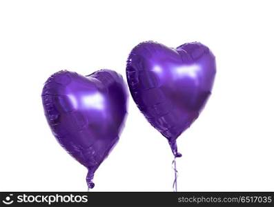 holidays, valentines day and party decoration concept - close up of inflated helium heart shaped balloons over white background. close up of helium balloons over white background. close up of helium balloons over white background