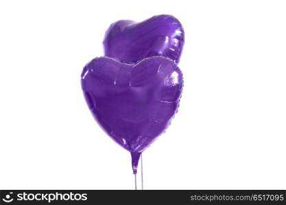 holidays, valentines day and party decoration concept - close up of inflated helium heart shaped balloons over white background. close up of helium balloons over white background. close up of helium balloons over white background