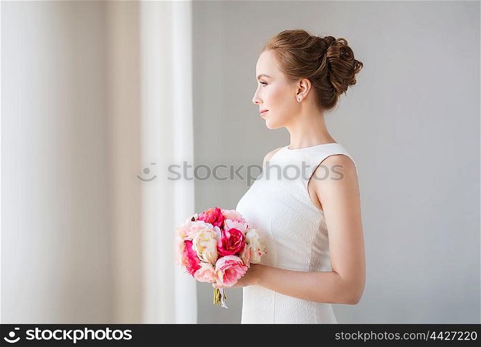 holidays, wedding and people concept - bride or woman in white dress with flower bunch