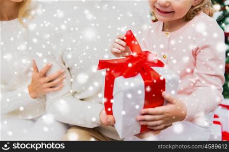 holidays, winter and christmas concept - close up of family with child holding gift box at home