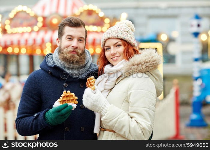 holidays, winter, christmas and people concept - happy couple in warm clothes walking in old town