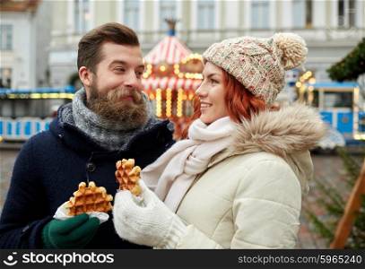 holidays, winter, christmas and people concept - happy couple in warm clothes walking in old town