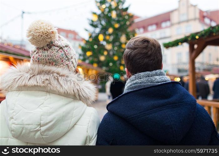 holidays, winter, christmas, tourism and people concept - close up of couple in old town from back