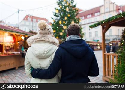 holidays, winter, christmas, tourism and people concept - close up of couple in old town from back