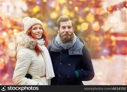 holidays, winter, christmas, tourism and people concept - happy couple in warm clothes walking in old town